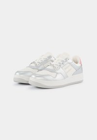Silver and white sneakers with a smooth leather upper, textured accents, perforated toe box, and a pink heel detail.