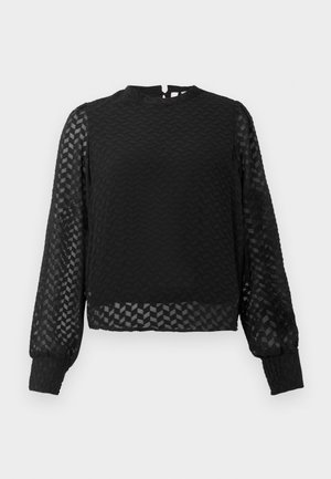 Melnā ilgā piedurkne augšdaļa ar teksturētu zigzaga rakstu, augstu izgriezumu un caurspīdīgām piedurknēm. Iespējams aizmugurējais atslēgas caurums un pieguļošas aproces.