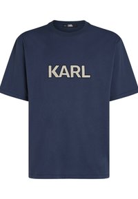 T-shirt en coton bleu marine avec un col rond et des manches courtes, ornée d'un logo beige "KARL" brodé sur la poitrine.
