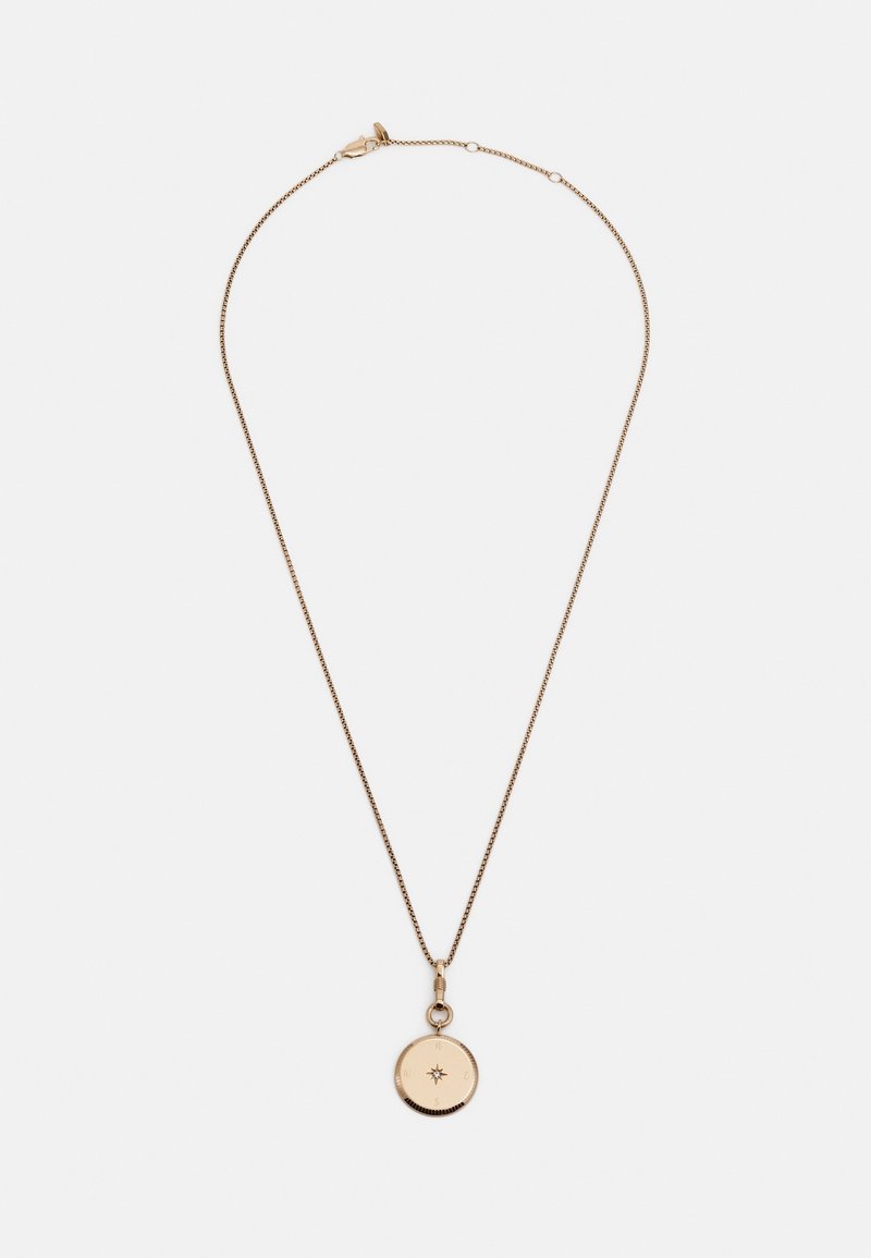 Collier délicat en chaîne d’or avec un pendentif rond gravé d'une étoile suspendu au centre, sur fond blanc.