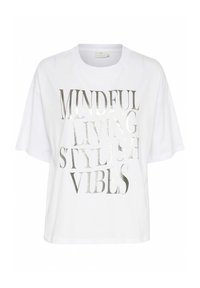 T-shirt oversized blanc en coton. Présente un texte métallisé argenté : « VIVRE EN CONSCIENCE, VIBRATIONS STYLÉES ». Manches courtes et design col rond.