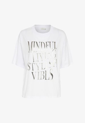 White oversized t-shirt made of cotton. Features metallic silver text: “MINDFUL LIVING STYLISH VIBES.” Short sleeves and crew neck design.