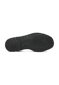 Rubber shoe sole with a textured pattern, featuring hexagonal and wave shapes. The color is predominantly black with slight variations.