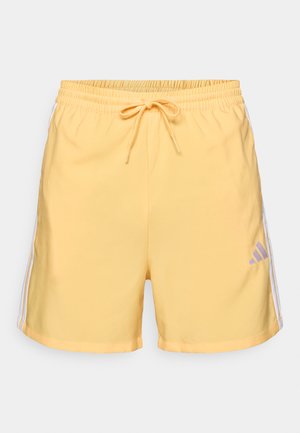 Pantaloncini sportivi gialli con vita elastica, coulisse regolabile e strisce laterali bianche. Caratterizzati da un piccolo logo viola sulla parte anteriore.