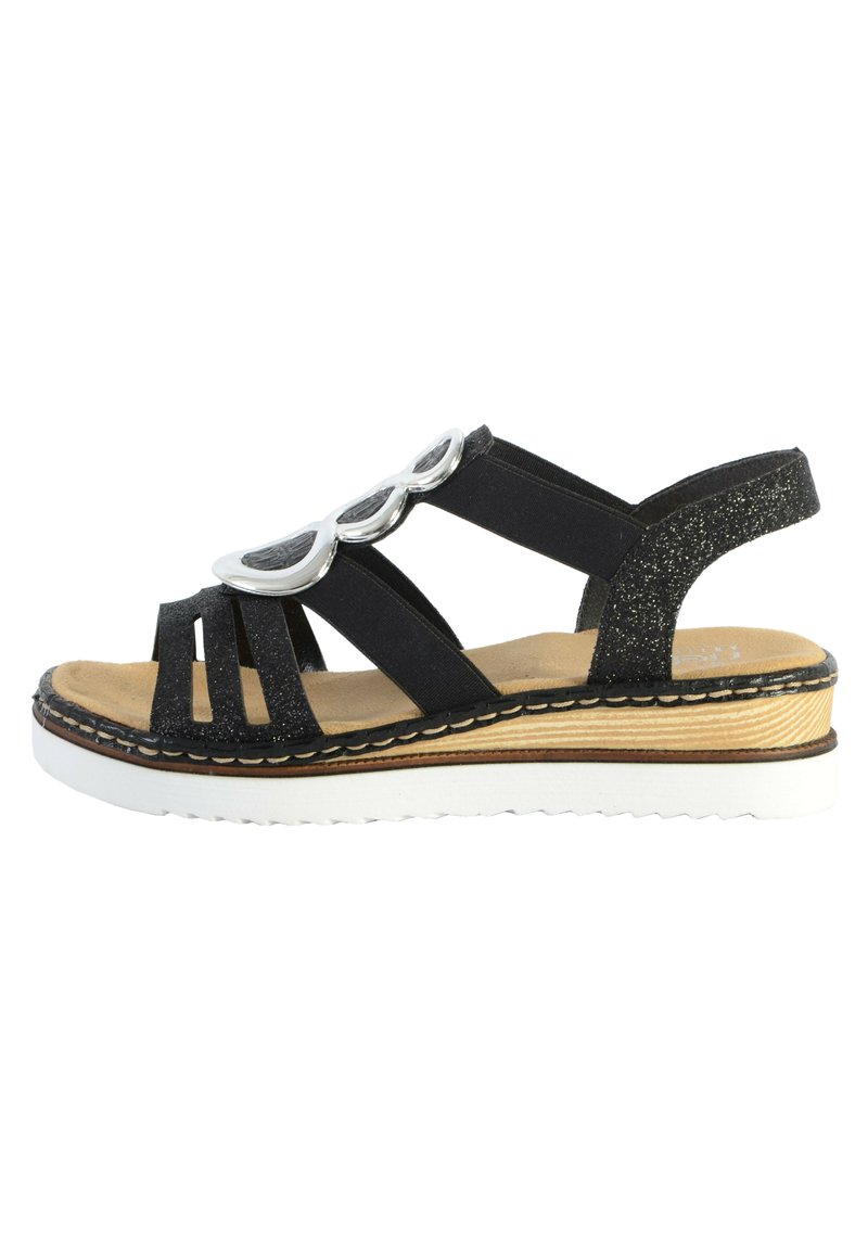 Sandalo nero con parte superiore glitterata e dettagli decorativi argentati, caratterizzato da un design open-toe e una suola bianca spessa con effetto legno.
