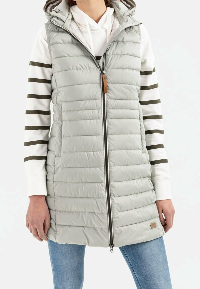 Light grey puffer vest with a zip front, side pockets, and hood. Features horizontal quilted pattern and a brown leather accent on the hem.
