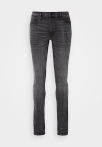 Jean denim noir slim avec légère décoloration sur les cuisses et poches avant cousues, présenté sur fond blanc.