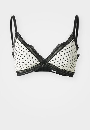 Zwart-witte polkadot bralette met kantafwerking, met verstelbare bandjes en een driehoekige vorm. Zachte, gladde stofstructuur.