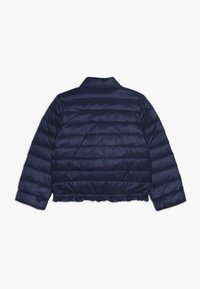 Marinblå pufferjacka, kviltad design med horisontella sektioner, kortare längd, ribbad nederkant och en liten krage. Slät, blank tygkänsla.