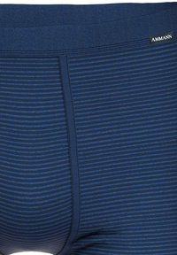Navy blue men's boxer briefs with horizontal stripes and a textured waistband. Features a logo tag and smooth fabric throughout.