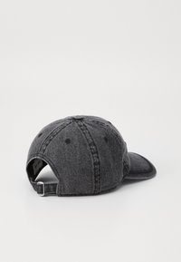Black denim baseball cap with a curved brim, six-panel design, stitching accents, and an adjustable metal strap at the back.
