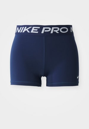 Mørkeblå idrettsshorts med bred elastisk midje som har "NIKE PRO" i hvitt. Glatt tekstur med flatlock-sømmer og kontrastlogo.