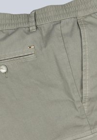 Light gray shorts made of textured fabric, featuring a button closure, a side pocket with a black stripe, and a small metallic accent.