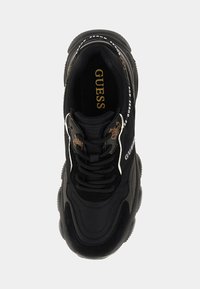 Black sports shoe with a textured upper, featuring a logo on the side, thick sole, and contrasting white accents along the design.