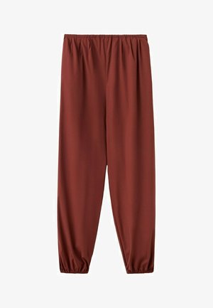 Pantalon ample marron rouille avec taille élastique et bas resserrés élastiqués, présenté sur un fond blanc.
