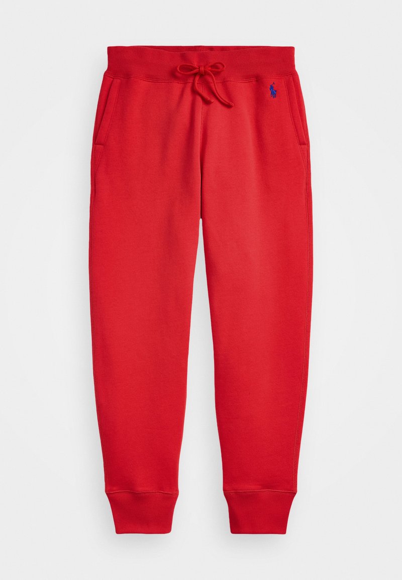 Red sweatpants made of soft fabric, featuring a drawstring waistband, two side pockets, and elastic cuffs. Small logo in blue on left thigh.