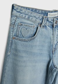 Jasnoniebieskie dżinsy z denimu z małym wyhaftowanym sercem na przedniej kieszeni na monety oraz metką Stradivarius na talii.