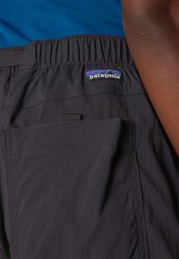Sorte shorts fremstillet af letvægtsstof med elastisk talje. Har en lomme med patch og Patagonia-logoet i farverig syning.