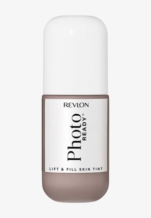 Flacon de teint Revlon Photo Ready Lift & Fill avec teinte beige et bouchon blanc, conçu pour la couverture et l'amélioration de la peau du visage.
