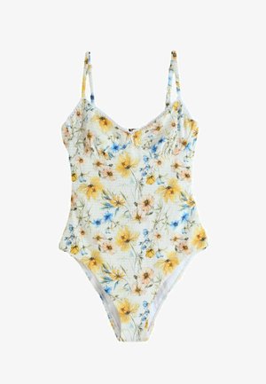 Egyrészes fürdőruha vékony pántokkal, texturált anyagból, sárga, kék és őszibarack színű virágmintával fehér alapon.