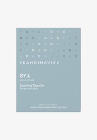 Scented candle box in soft blue with silver patterned accents, featuring "SKANDINAVISK" brand text and product details in white.