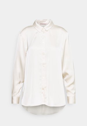 White satin long-sleeve shirt with a collared neckline, button front, and curved hem. Soft texture with a smooth finish.