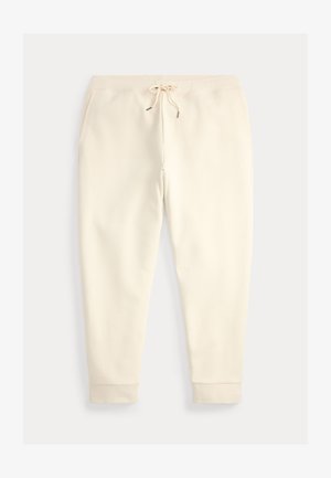 Joggebukse i kremfarge med fremre lommer, elastisk midje og snor, vist flatt på en lys bakgrunn.