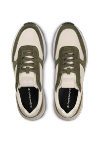 Sneakers met een beige stofbovenkant en groene suède accenten. Vetersluiting ontwerp met een witte tussenzool en zwarte buitenzool. Geperforeerde logo-detail.