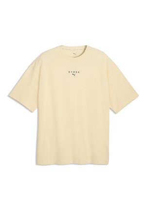 T-shirt a maniche corte color beige chiaro senza motivi, con "HYROX" e un piccolo logo Puma nero stampato sul petto.