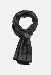 Écharpe noire en tissu doux, présentant des motifs texturés de roues et d'animaux, avec des bords frangés. Design long et en boucle.