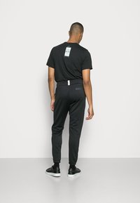 Nike Sportswear AIR PANT - Calças de fato de treino - black/light bone