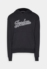 Sweat à capuche noir avec une grande poche avant et un logo script "Jordan" blanc sur la poitrine.