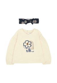 Camicia a maniche lunghe color crema con un design floreale blu e un cerchietto blu navy con motivo floreale; tessuto morbido, maniche arricciate e scollatura rotonda.