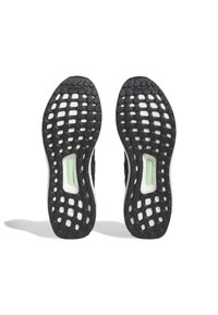 Pair of black and white running shoe soles with grid pattern and Continental rubber grip, viewed from the bottom.