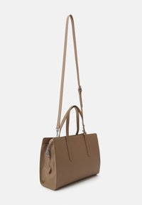 Borsa a mano in finta pelle marrone con due manici superiori e una lunga tracolla regolabile, dotata di un compartimento con zip e una forma strutturata.