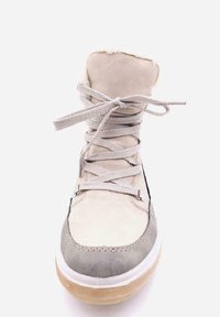 Bota de invierno beige y gris con parte superior de ante texturizado, cuello acolchado y cordones planos. Suela de goma con una ligera curva en la punta.