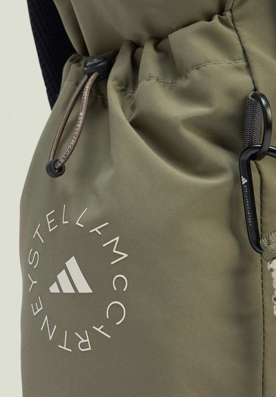 Olive green drawstring backpack with a glossy texture, featuring a white logo, adjustable cord lock, and a black metallic carabiner.