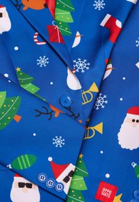 Blue suit jacket featuring festive patterns, including Santa, snowflakes, Christmas trees, and presents; includes a blue button and logo tag.