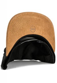 Black cap with a brown suede brim, featuring stitching details and a logo on the underside. The inner lining is black fabric.