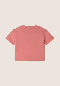 T-shirt corta a maniche corte in rosa corallo. Realizzata in cotone morbido con scollo rotondo e texture liscia. Senza motivi o accenti visibili.