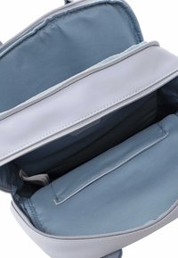 Grå och ljusblå tygväska med dragkedja; insidan har en slät foder, en ficka och organiserade fack.