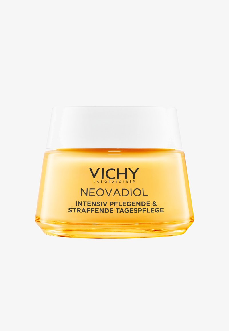 Vichy Neovadiol cream in a clear glass jar; yellow cream inside; white, smooth lid; features bold black lettering on the front.