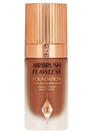 Foundation bottle with a gold ribbed cap, featuring a brown gradient glass body, and labels in gold text stating "Airbrush Flawless Foundation."