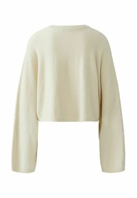 Cream-colored cropped sweater with long sleeves, featuring a soft texture and ribbed neckline. Simple design, no visible patterns or accents.