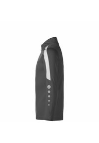 Maglietta nera a maniche lunghe con pannello grigio sulla spalla e accenti circolari sulla manica. Realizzata in un tessuto testurizzato e traspirante.