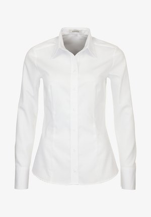 Chemise blanche à manches longues, avec un ajustement cintré, un col pointu et un ourlet droit. Fabriquée dans un tissu lisse avec une texture subtile.
