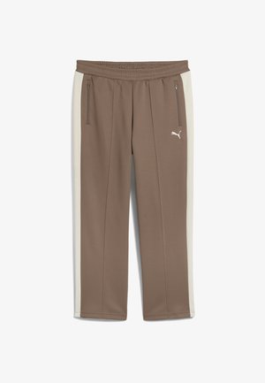 Pantaloni atletici maro cu panouri laterale în crem deschis. Realizați dintr-un material moale, au buzunare cu fermoar și un elastic la talie.