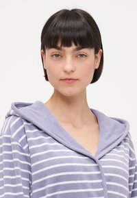 Purple and white striped robe with a hood. Made of soft fabric, featuring a button closure and a relaxed fit.