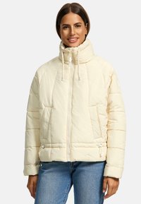 Puffy white jacket with high collar, zip front, and drawstring accents. Features side pockets and ribbed cuffs. Soft, quilted texture.