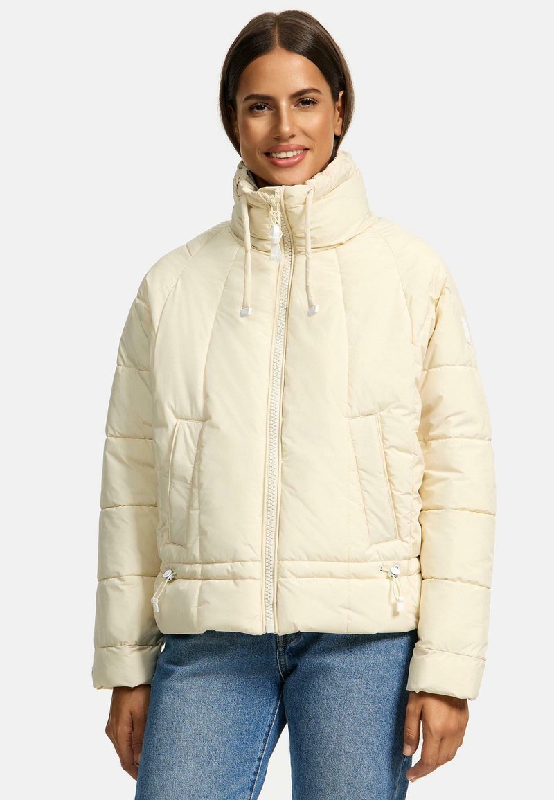 Puffy white jacket with high collar, zip front, and drawstring accents. Features side pockets and ribbed cuffs. Soft, quilted texture.